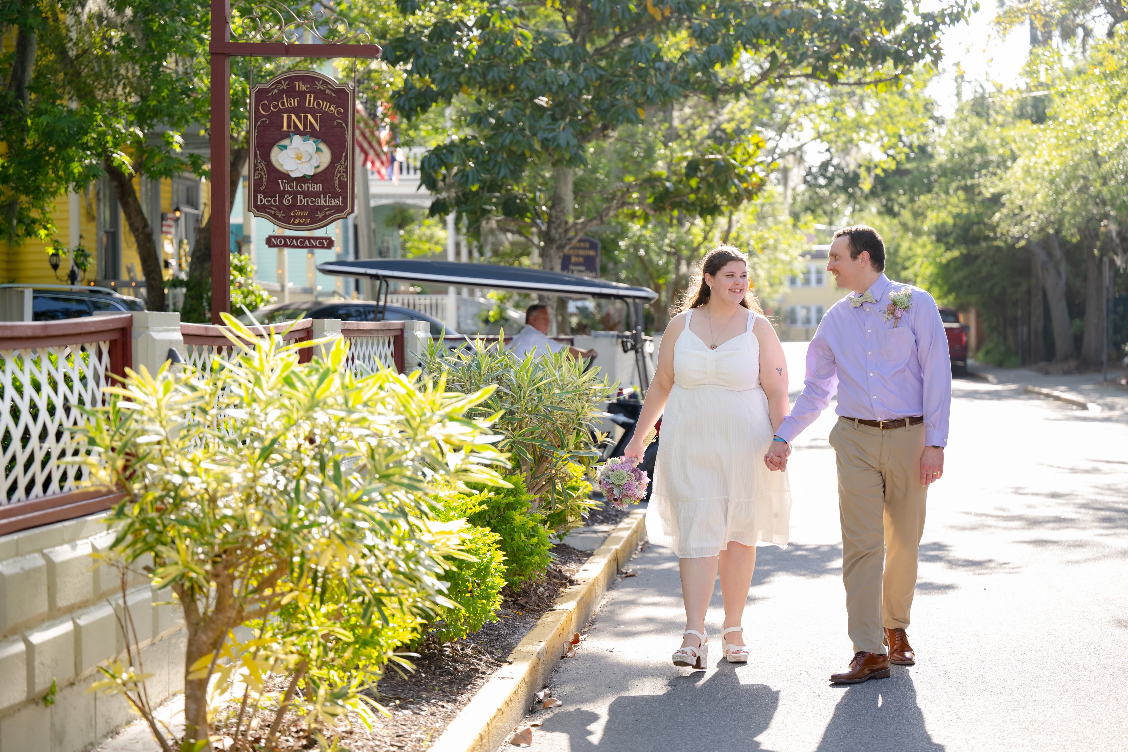 Couple walking and holding hands by Cedar House Inn