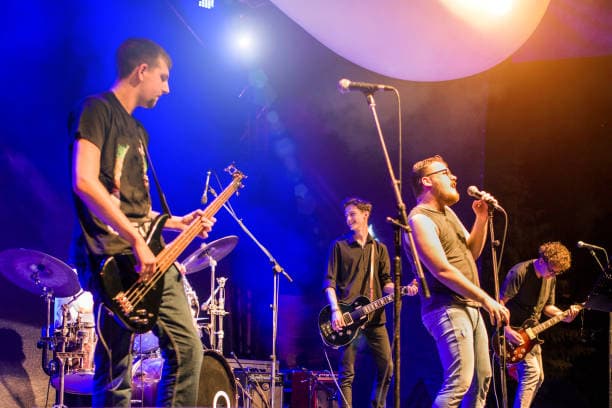 Young music band performing at rock concert Young music band performing at rock concert